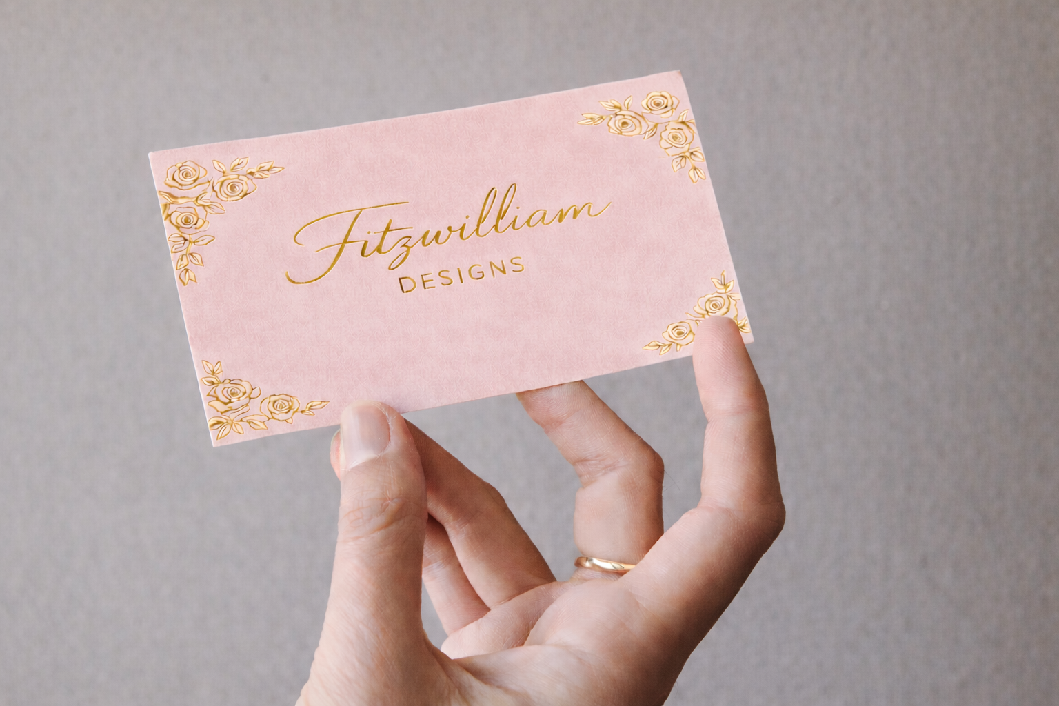 Premium pink gold edge business cards with blind embossing for female lawyers and accountants.