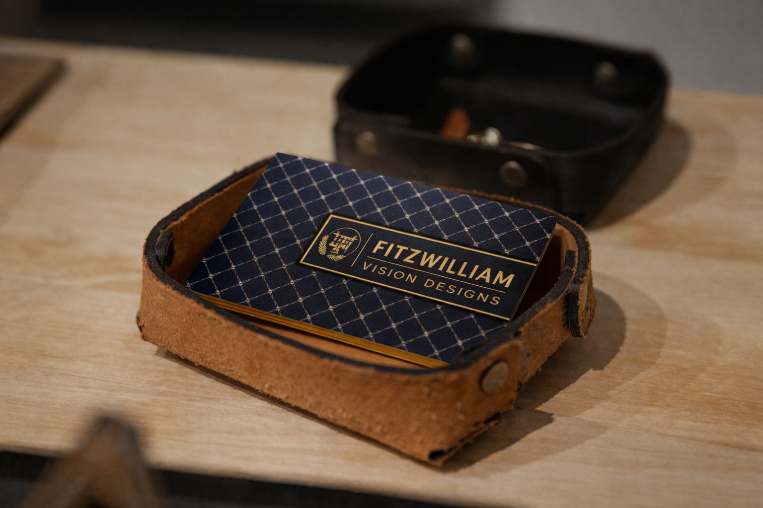 Luxury business cards in Ireland with a trellis pattern, gold foil logo and typography, gold edge gilding, and embossed reverse detailing.